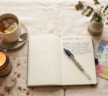 sunday reset routine flat lay with candle journal and skincare