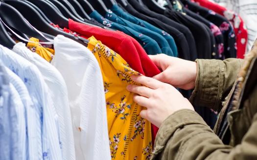 checking fabric care labels while thrift shopping